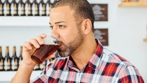 Man tasting a dark beer